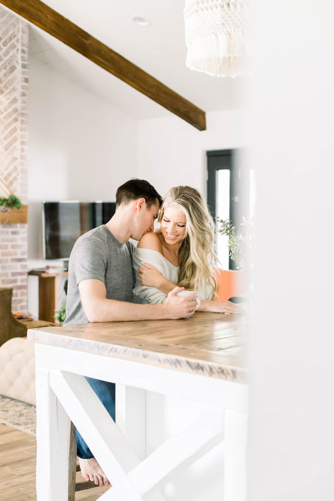 Examples of lifestyle photography - young couple poses for lifestyle portraits in their kitchen